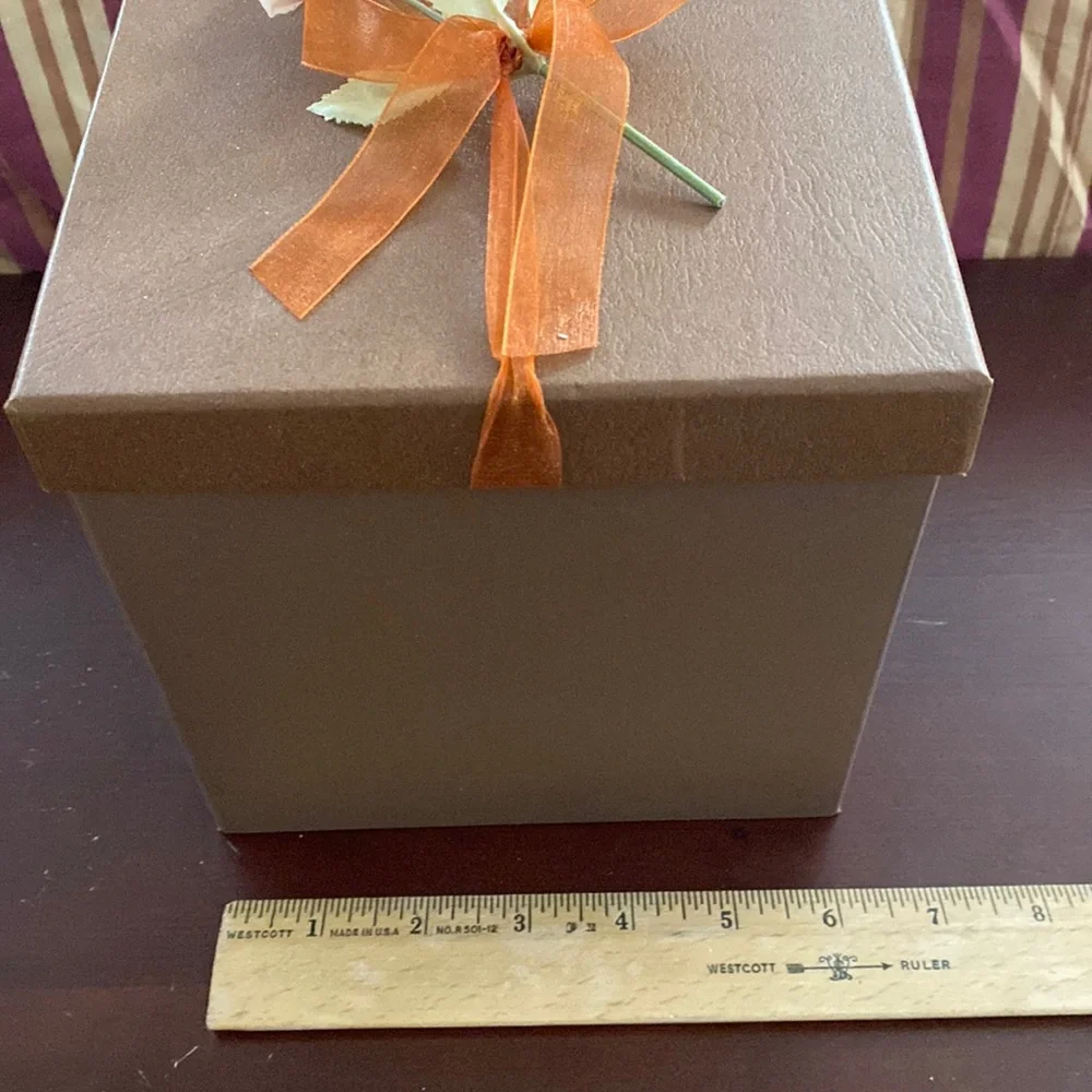 Pretty storage/gift box. Cardboard. Bronzish color with orange ribbon and flower